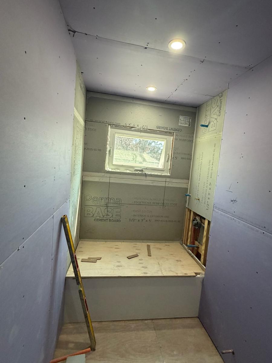 Cement board installation around tub surround with level