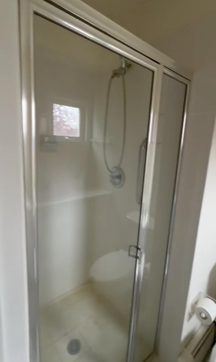 Old fiberglass shower stall before renovation