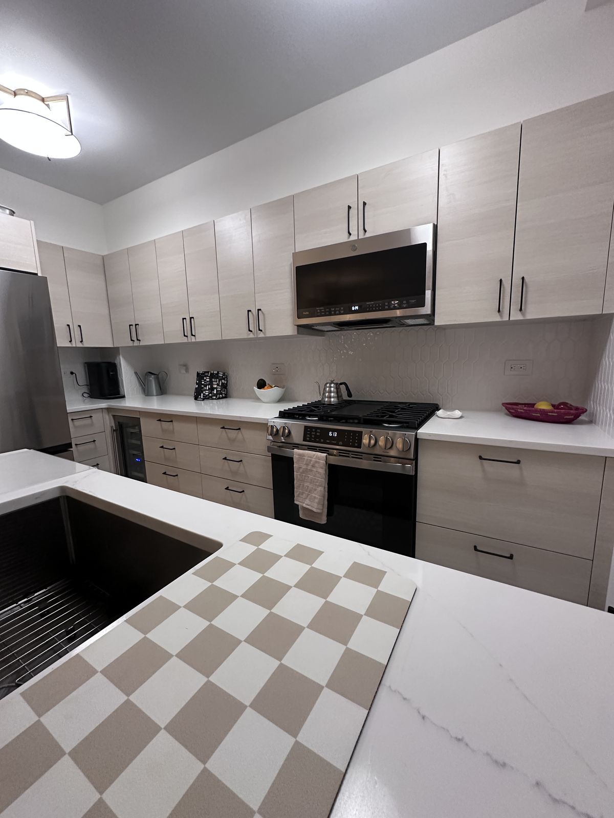 White quartz countertop with grey veining on shaker cabinetry