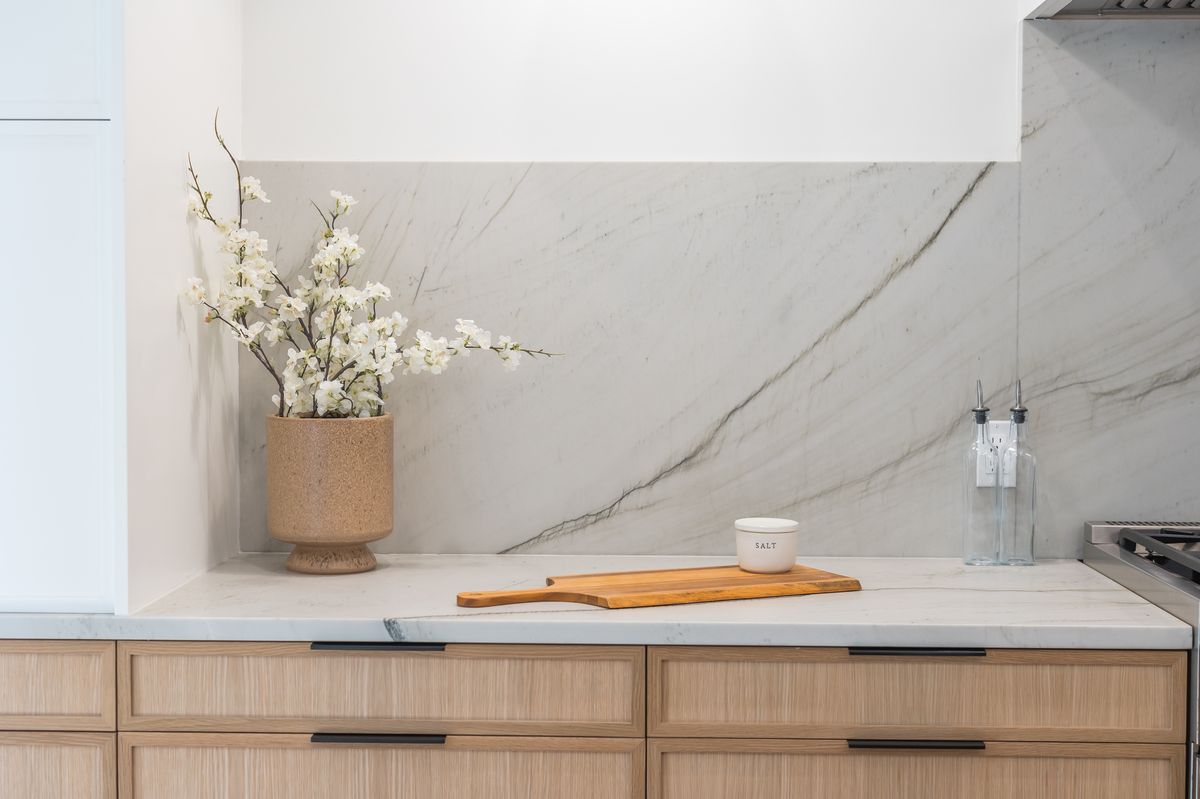 Kitchen with quartz countertops, white cabinets, and modern hardware
