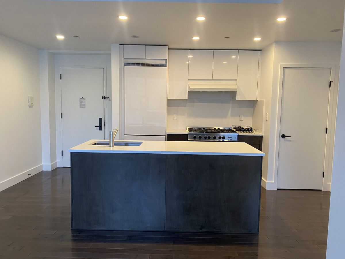 Finished kitchen with calacatta stone countertop and tile backsplash