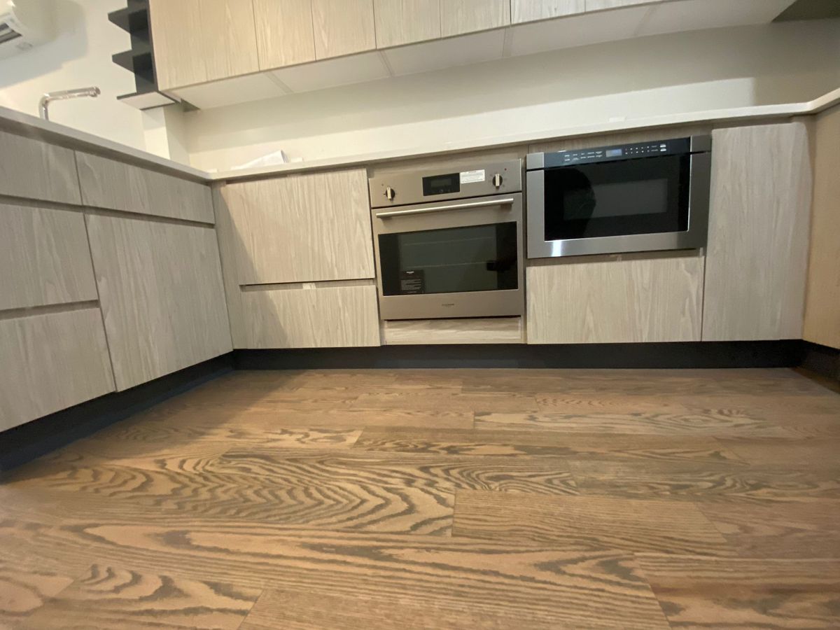 Finished kitchen with custom millwork cabinetry and stone countertops