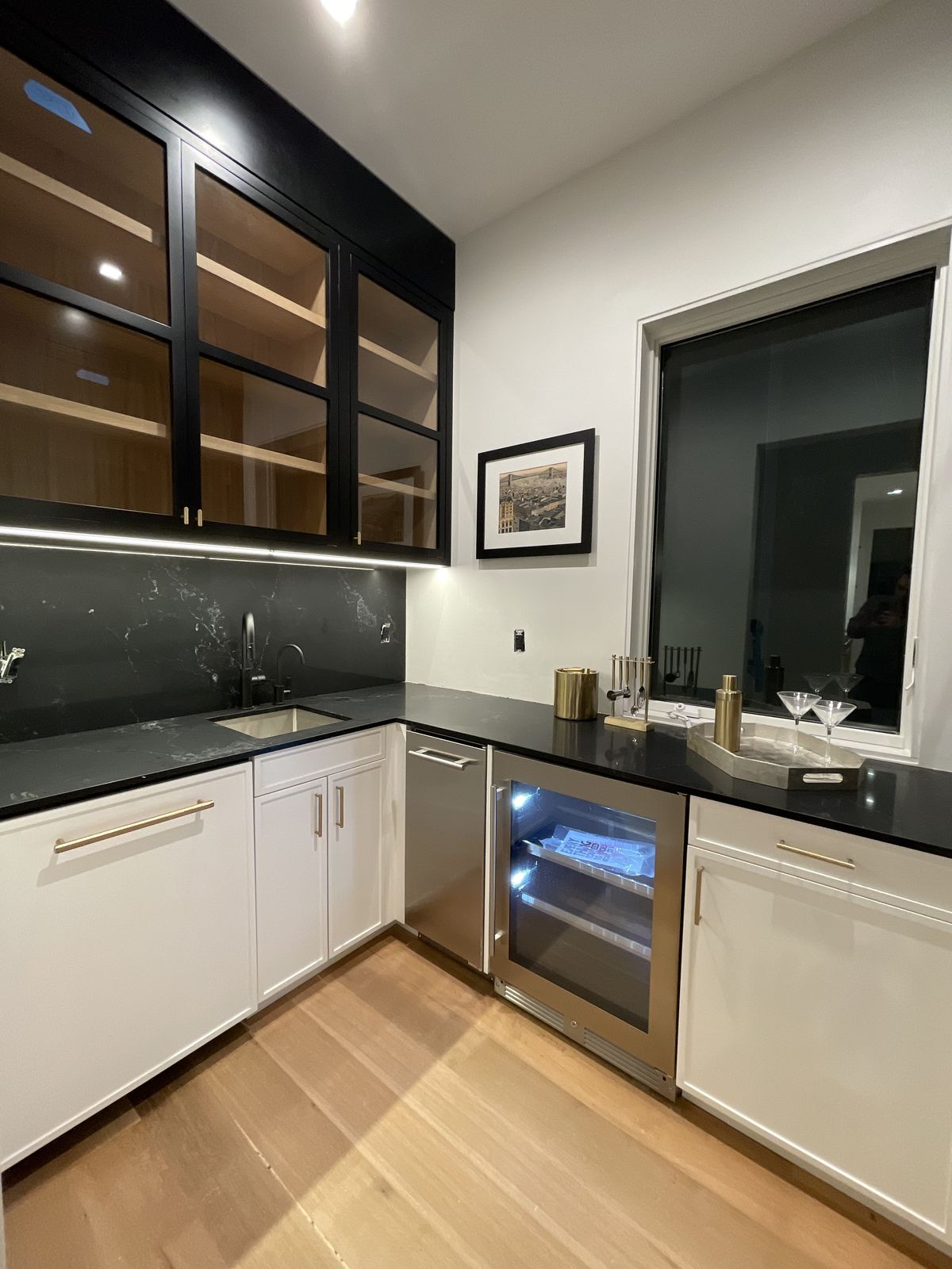 Walk-in closet with island, shoe shelving, and custom drawer system