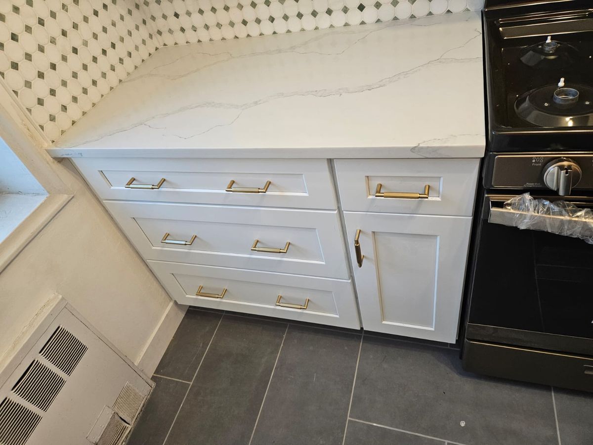 White kitchen cabinetry with subway tile backsplash and quartz countertop