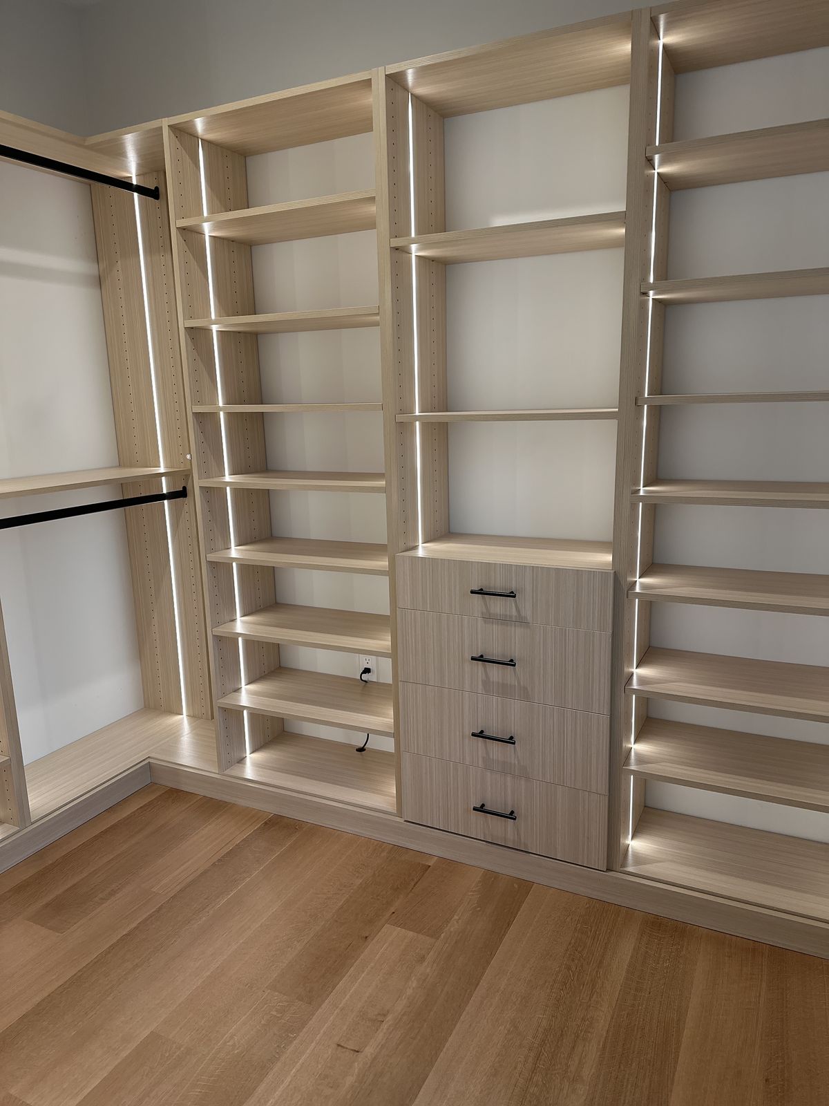 Custom floor-to-ceiling wardrobe with panel doors and hardware