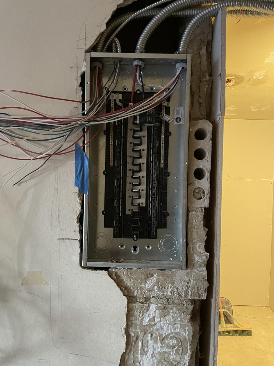 Electrical panel area with conduit and wiring runs