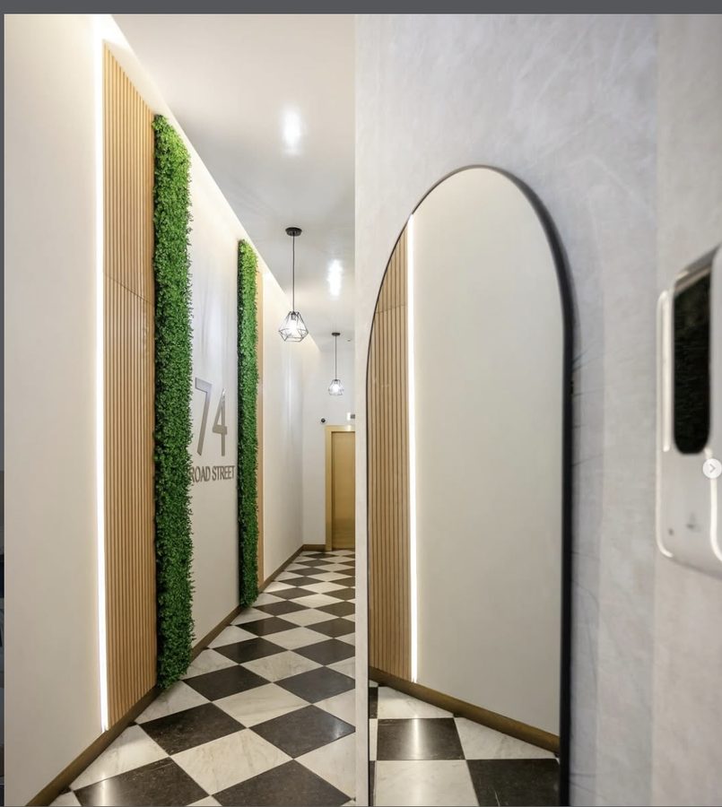 Lobby renovation at 74 Broad Street featuring living green wall and LED accent lighting