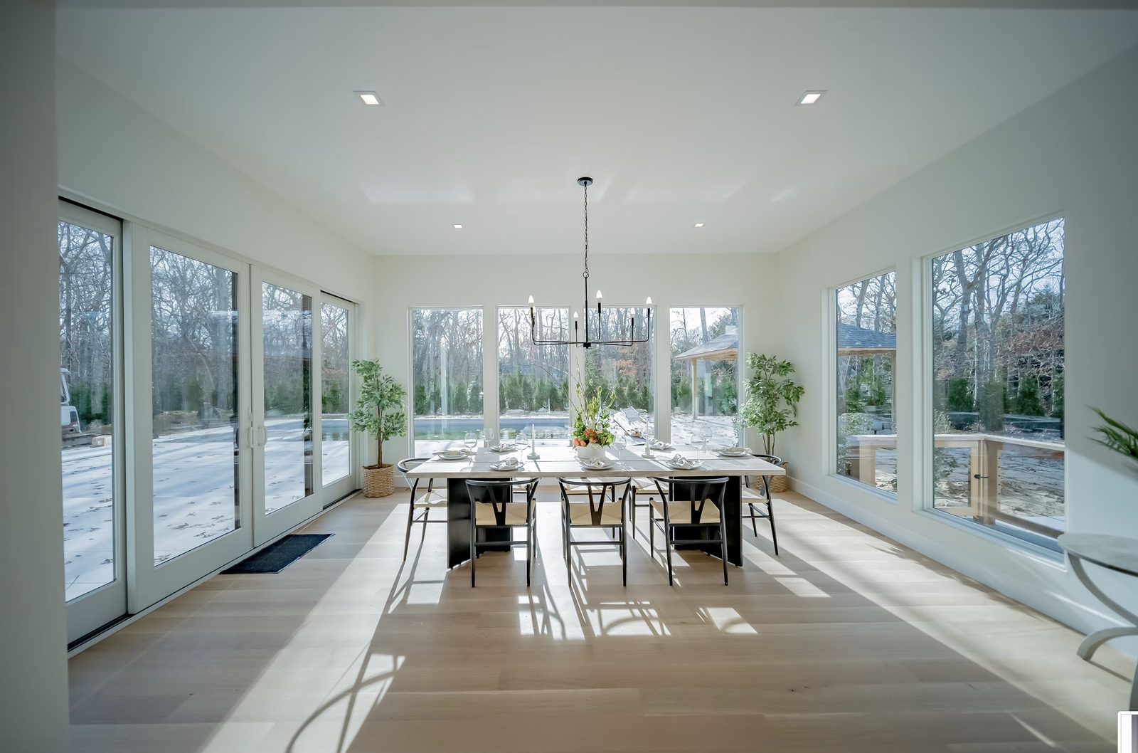Open-concept dining room with coffered ceiling and custom millwork in modern farmhouse