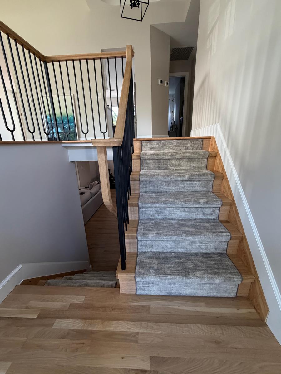 Oak staircase with carpet runner viewed from upper landing