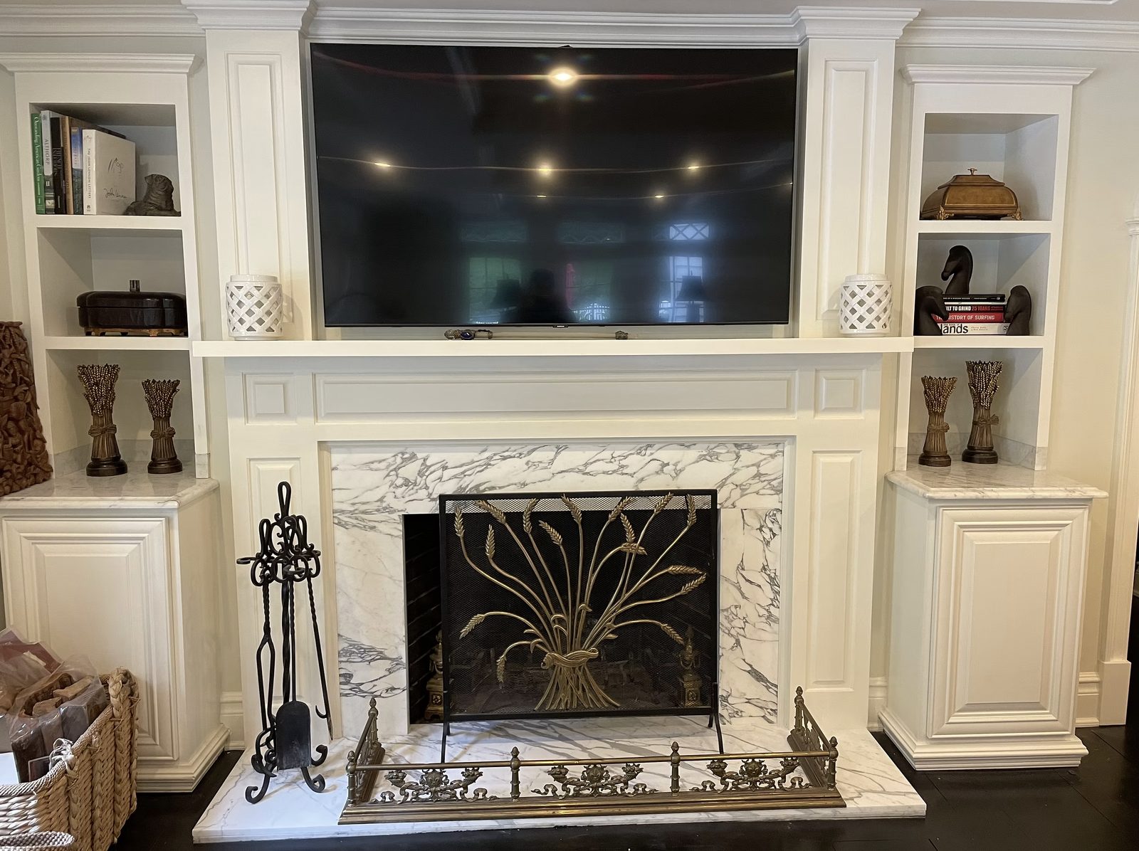 Custom marble fireplace surround with carved mantel in estate living room renovation